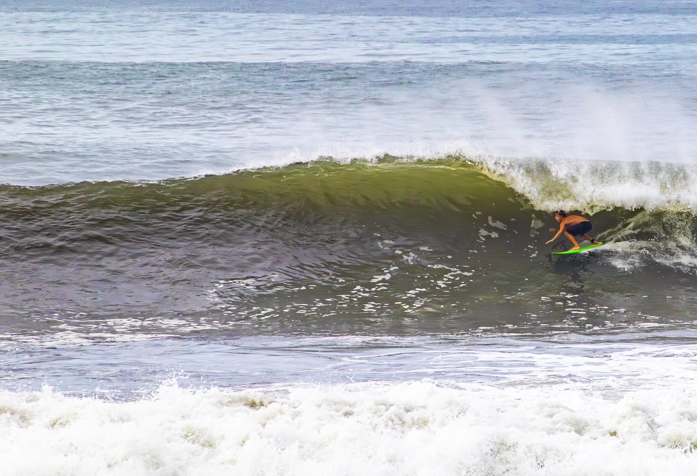 Advanced surfer performing a critical turn on a fast-breaking wave