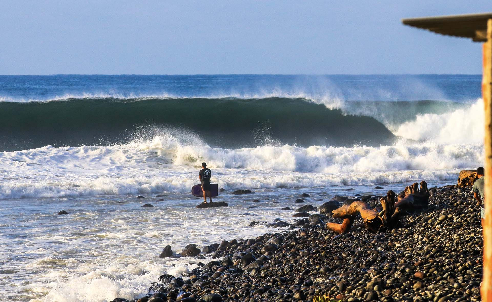 Surfer riding a legendary point break wave at Punta Roca, El Salvador